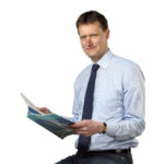 Professor Carl-Eric Wilén sitting on a high chair